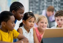 Elementary students working on a tablet together