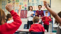 Photo of two teachers leading a classroom