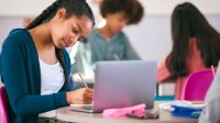 Student writing in class