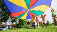 Preschool class playing with parachute