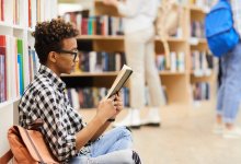 Photo of teen reading book.