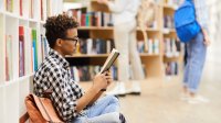 Photo of teen reading book.