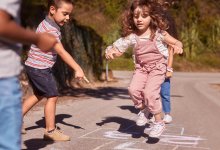 Photo of elementary school children playing hopscotch