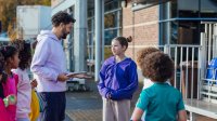 Teacher talking to student outside