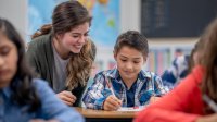Elementary teacher working with a student