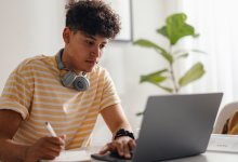 Photo of high school student working on laptop