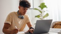 Photo of high school student working on laptop