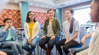 Students making the most of a quick check-in by participating in an SEL focused group discussions