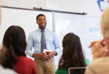 Teacher practicing a lesson in front of colleagues