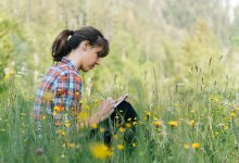 Photo of high school student writing in field