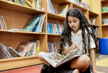 Photo of middle school student reading graphic novel at school