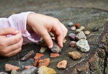 Photo of child counting rocks