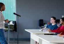 Photo of guest speaker talking to high school classroom