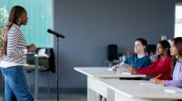 Photo of guest speaker talking to high school classroom