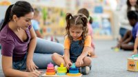 Photo of pre-k student and teacher in classroom