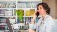 Teacher making a difficult phone call home to a student's family with confidence