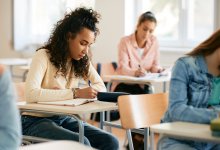 High school students completing a letter-writing assessment
