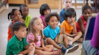Elementary students actively participating in a picture book read-aloud to build a sense of belonging