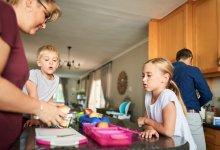 A photo of a family getting ready for school by packing lunch