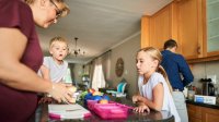 A photo of a family getting ready for school by packing lunch