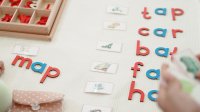 Students using letter blocks to spell out images on flashcards