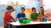 A small group of young students completing a drawing activity in the early morning
