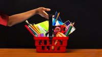 hand lifting a basket of school supplies