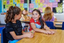 Two elementary students talking