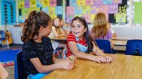 Two elementary students talking
