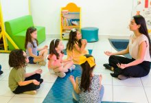 A teacher managing a classroom of young elementary students through meditation