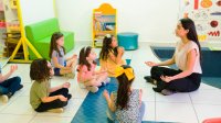 A teacher managing a classroom of young elementary students through meditation