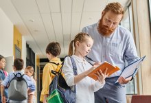 Teacher and student talking in hallway