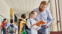 Teacher and student talking in hallway