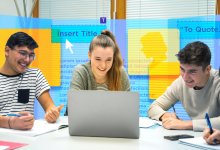 High schoolers using a laptop to build out a brochure for a school project