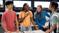 A small group of high school students collaborating on a leadership project