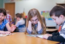 Elementary students reading in pairs