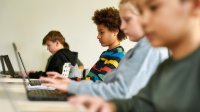 Elementary students working on laptops