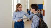 A principal prioritizing school culture talking to a student
