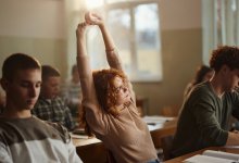 High school student stretching in class