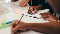 Students taking creative notes with different writing instruments