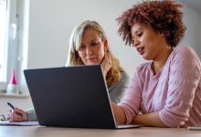 Two coworkers working on a laptop