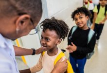 Educator greeting students