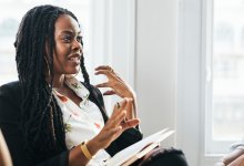 A photo of a principal engaged in a mediation with two implied teachers whose faces are out of the boundaries of the image.