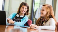 Two middle school students working together