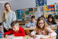 Teacher watching students work