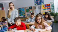 Teacher watching students work