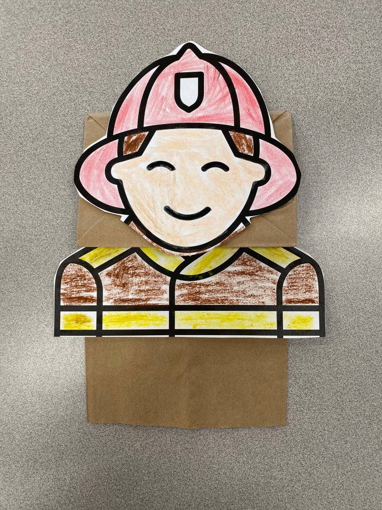 An image of a firefighter puppet made using a brown paper bag