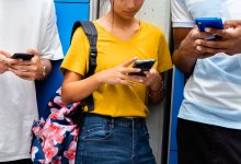 Teenagers using smartphones