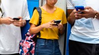 Teenagers using smartphones