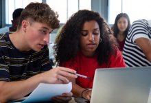 High school students working together on a computer